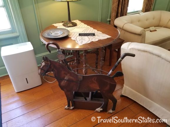 Maclay living room with horse walking cane holder
